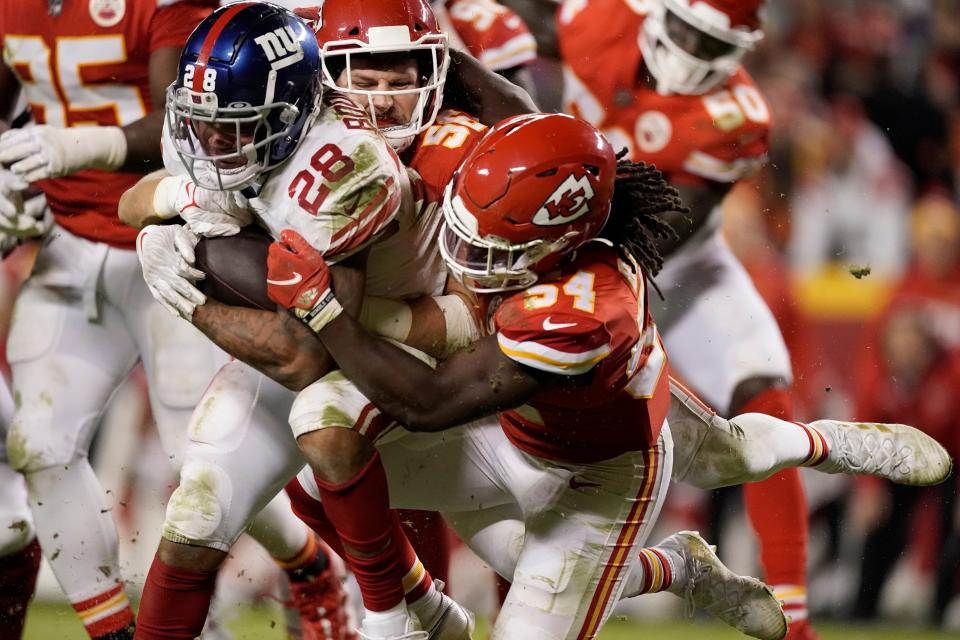 Kansas City Chiefs linebacker Nick Bolton (54) takes down New York Giants running back Devontae Booker (28) during a game last season.