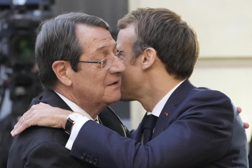 France's President Emmanuel Macron, right, greets President of Cyprus Nicos Anastasiades before a conference with several world leaders in Paris, Friday, Nov. 12, 2021. France is hosting an international conference on Libya on Friday as the North African country is heading into long-awaited elections next month. (AP Photo/Francois Mori)