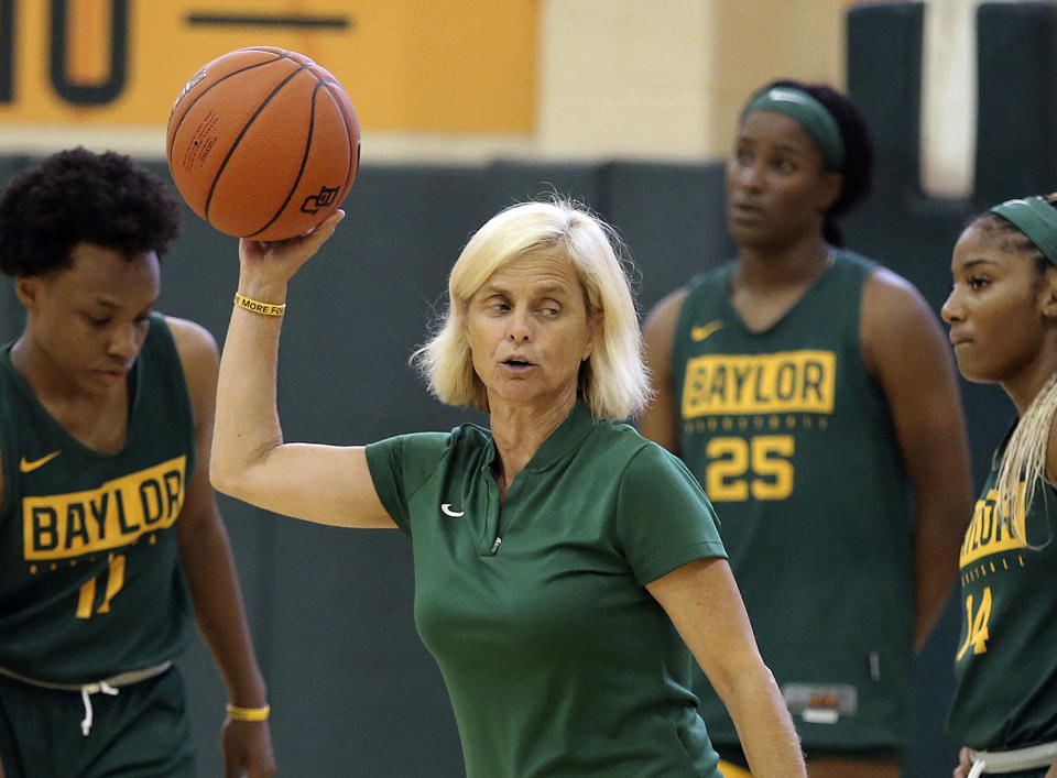 FILE - In this Sept. 30, 2019, file photo, Baylor women's coach Kim Mulkey, center, talks with players during the NCAA college basketball team's practice in Waco, Texas. The NCAA Division I Council on Wednesday, June 17, 2020, approved a plan to allow college basketball players to start working with their coaches for the first time since the pandemic wiped out March Madness. The summer access period for men's and women's players will begin July 20. (Jerry Larson/Waco Tribune-Herald via AP, File)