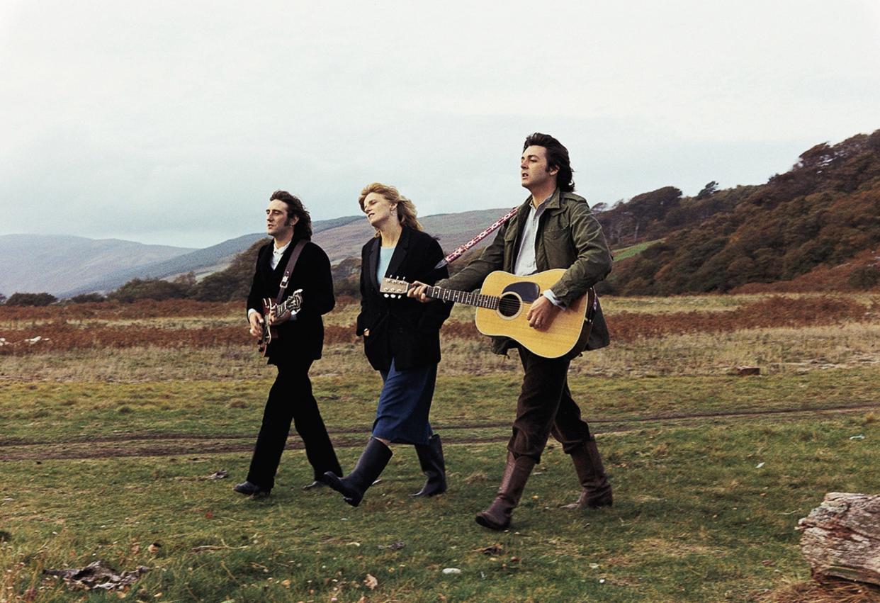 Denny Laine (left), Linda McCartney and Paul McCartney traverse the countryside for the "Mull of Kintyre" video.