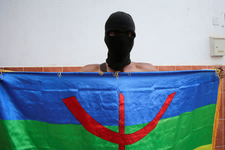 A protester holds an Amazigh flag during a demonstration against alleged corruption in the town of Al-Hoceima, Morocco July 20, 2017. REUTERS/Youssef Boudlal