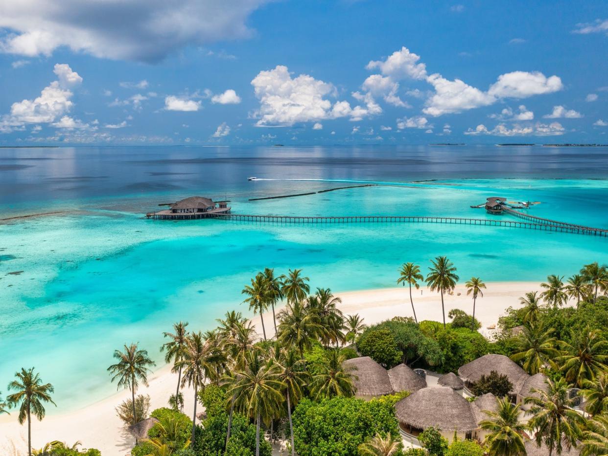 aerial shot of luxury villa in the water off the coast of the maldives