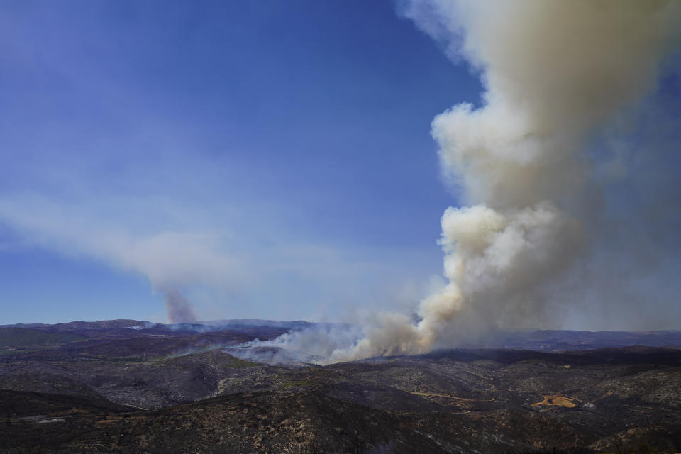 Clouds of smoke rise during a wildfire near Altura, eastern Spain, on Friday, Aug. 19, 2022. Up to early August, 43 large wildfires — those affecting at least 500 hectares (1,235 acres) — were recorded in the Mediterranean country by the Ministry for Ecological transition, while the average in previous years was 11. The European Forest Fire Information System estimates a burned surface of 284,764 hectares (704,000 acres) in Spain this year. That's four times higher than the average since records began in 2006. (AP Photo/Alberto Saiz)