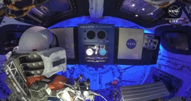 An interior presumption    of the Orion capsule shows a sensor-equipped mannequin that’s been nicknamed “Commander Moonikin Campos” sitting successful  the spot   astatine  left. A zero-G indicator, styled aft  the Snoopy quality  from the “Peanuts” comic strip, is floating to the mannequin’s little   right. The console for the experimental Alexa-like Callisto instrumentality  is beforehand   and center.