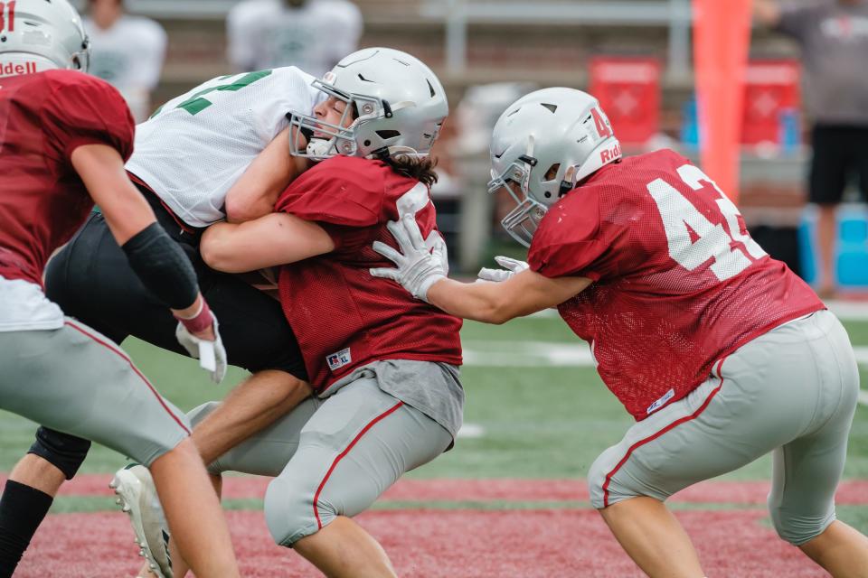 The Dover defense is seen blocking against GlenOak during their scrimmage, Saturday, Aug. 6 at Crater Stadium.