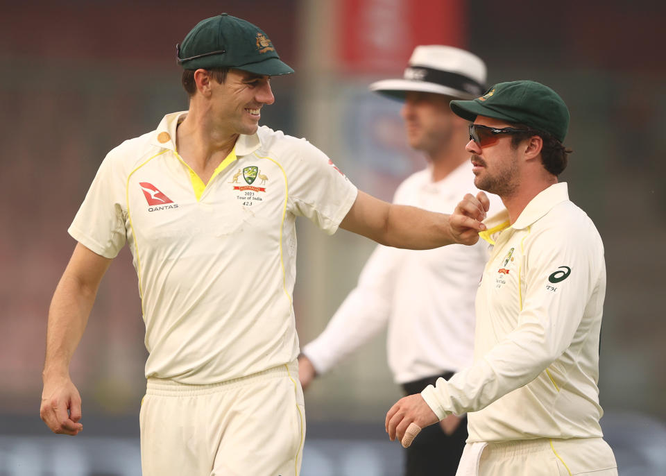 Pat Cummins, pictured here speaking with Travis Head during the second Test between Australia and India.