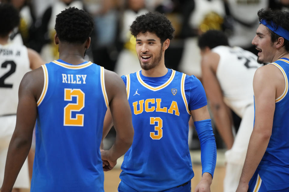 UCLA guard Johnny Juzang (3 celebrates with forward Cody Riley, left, and guard Jaime Jaquez Jr. near the end of the team's NCAA college basketball game against Colorado on Saturday, Jan. 22, 2022, in Boulder, Colo. UCLA won 71-65. (AP Photo/David Zalubowski)