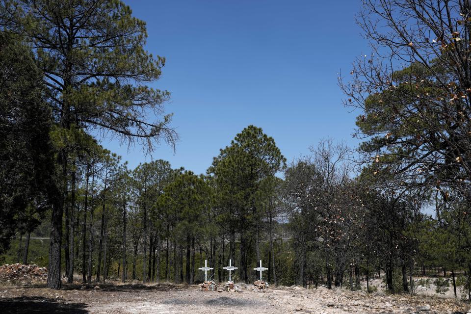 Crosses on the roadside mark the site where the bodies of Jesuit Priests Javier Campos and Joaquín Mora, and tourist guide Pedro Palma, were found after their 2022 murders, in different locations by a gang leader, on the outskirts of Cerocahui, Mexico, Monday, May 13, 2024. The National Guard established a permanent base in Cerocahui in response to the killings and the military remained in the area after the gang leader, El Chueco, was found dead in 2023. (AP Photo/Eduardo Verdugo)