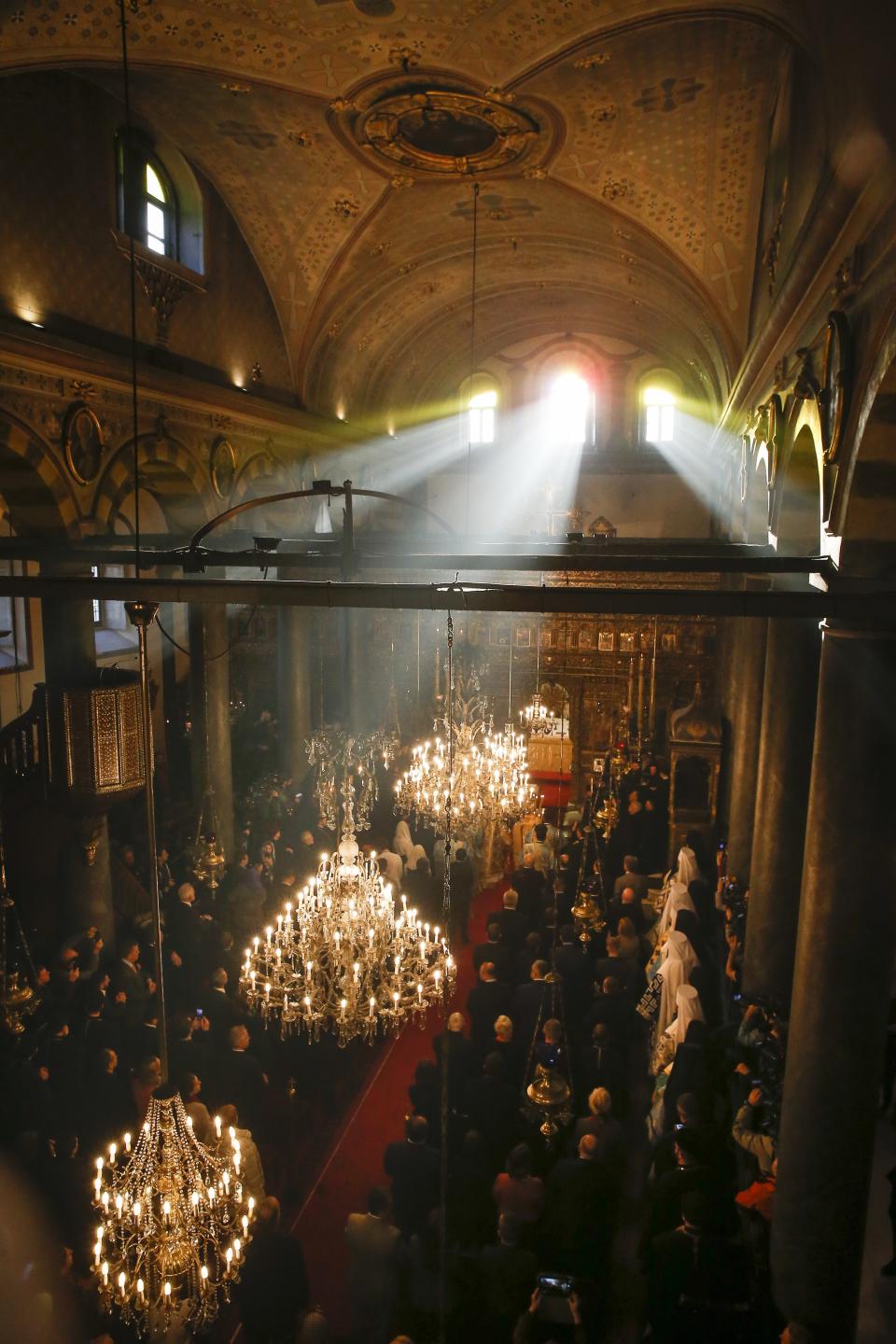 People and Orthodox priests attend a religion service at the Patriarchal Church of St. George in Istanbul, Sunday, Jan. 6, 2019. An independent Ukrainian Orthodox church has been created at a signing ceremony in Turkey, formalizing a split with the Russian church it had been tied to since 1686. (AP Photo/Lefteris Pitarakis)