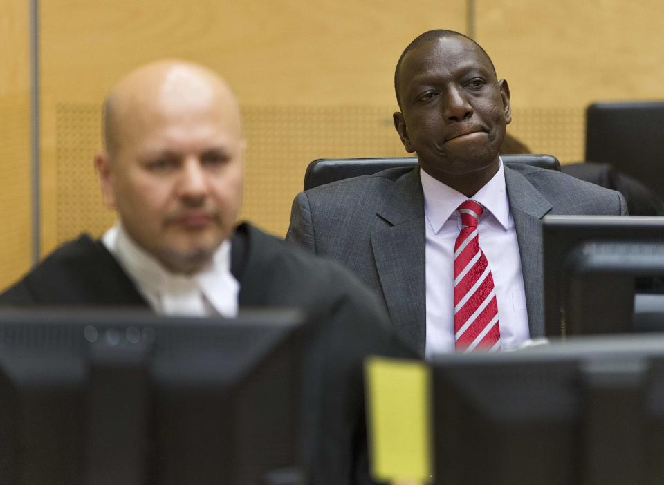 Kenya's Deputy President William Ruto (R) reacts as he sits in the courtroom before his trial at the International Criminal Court (ICC) in The Hague September 10, 2013. Ruto appeared at the International Criminal Court on Tuesday for the opening of his trial on charges of co-orchestrating a post-election bloodbath five years ago. Ruto and his co-accused, the broadcaster Joshua arap Sang, could face long prison terms if convicted.To the left is defense counsel Karim Khan. (REUTERS/Michael Kooren)