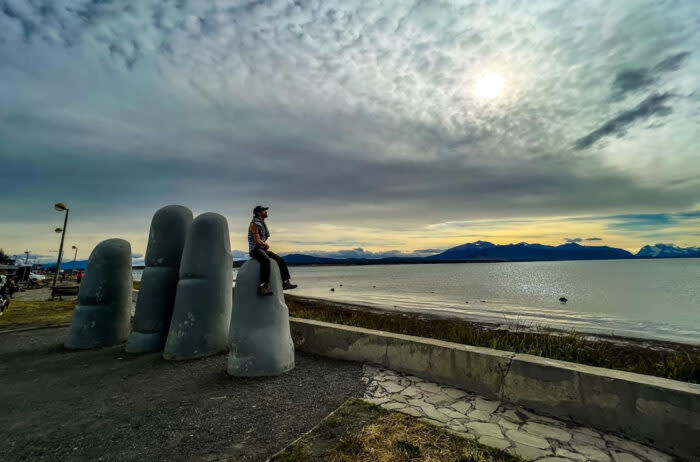 The author on a sculpture along the boardwalk of Puerto Natales, Chile; (photo/Daniel Posada)