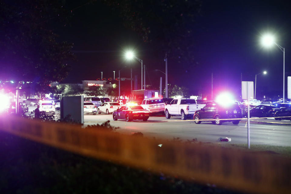 A row of vehicles and a UPS truck are seen behind police tape after a shooting Thursday, Dec. 5, 2019, in Miramar, Fla. Four people, including a UPS driver, were killed Thursday after robbers stole the driver’s truck and led police on a chase that ended in gunfire at a busy Florida intersection during rush hour, the FBI said. (AP Photo/Brynn Anderson)