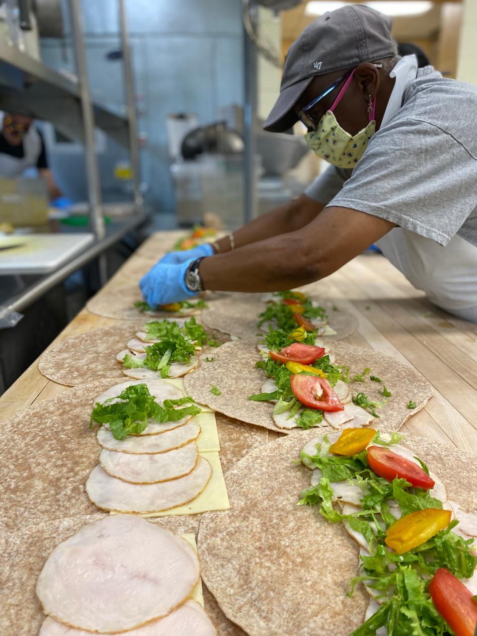 Island Grown Initiative volunteer Sheila Elliot prepares lunches for the organization's meals program in what has been a "borrowed" kitchen. The nonprofit, with an office in West Tisbury, recently purchased Kitchen Porch Catering in Edgartown with a commercial-grade kitchen.