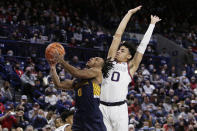 Merrimack guard Malik Edmead, left, drives to the basket and is fouled by Gonzaga guard Julian Strawther, right, during the first half of an NCAA college basketball game, Thursday, Dec. 9, 2021, in Spokane, Wash. (AP Photo/Young Kwak)