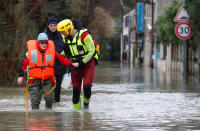 <p>An elderly woman is helped by fire brigade divers after she went back home to feed animals in a flooded residential area in Conde-Sainte-Libiaire, near Paris, France, Jan. 25, 2018. (Photo: Christian Hartmann/Reuters) </p>