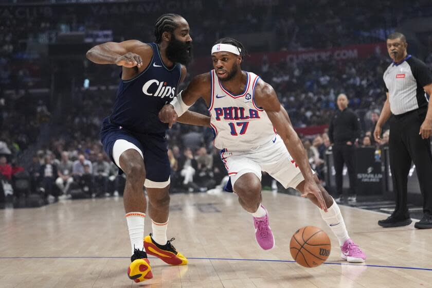 Philadelphia 76ers guard Buddy Hield (17) drives past Los Angeles Clippers guard James Harden.