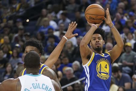 March 31, 2019; Oakland, CA, USA; Golden State Warriors guard Quinn Cook (4) shoots the basketball against Charlotte Hornets forward Michael Kidd-Gilchrist (14) during the fourth quarter at Oracle Arena. Mandatory Credit: Kyle Terada-USA TODAY Sports