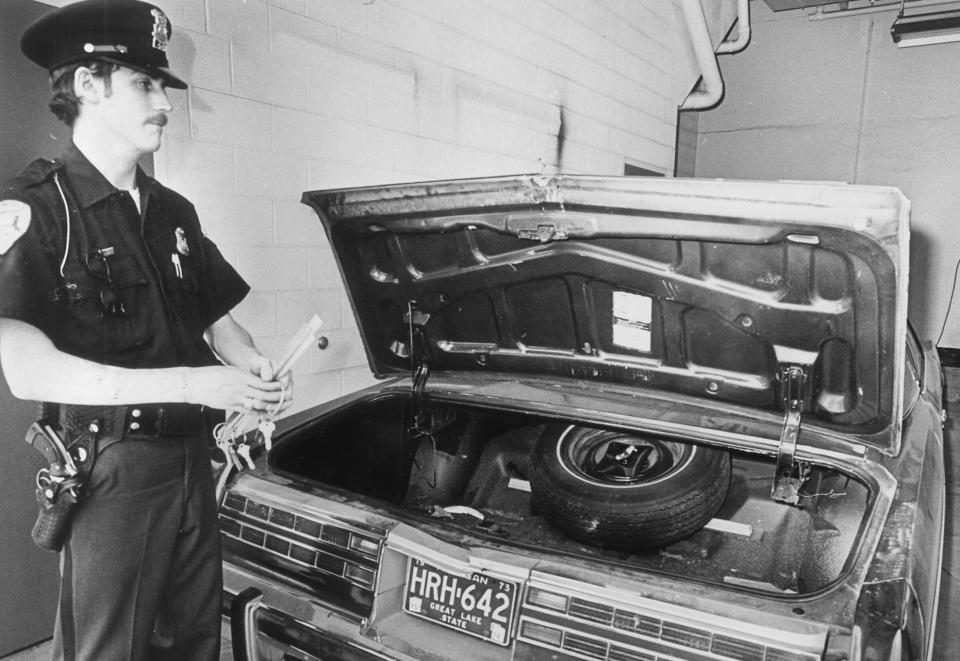 A Bloomfield Township police officer stands beside Jimmy Hoffa's car after the labor leader's disappearance.