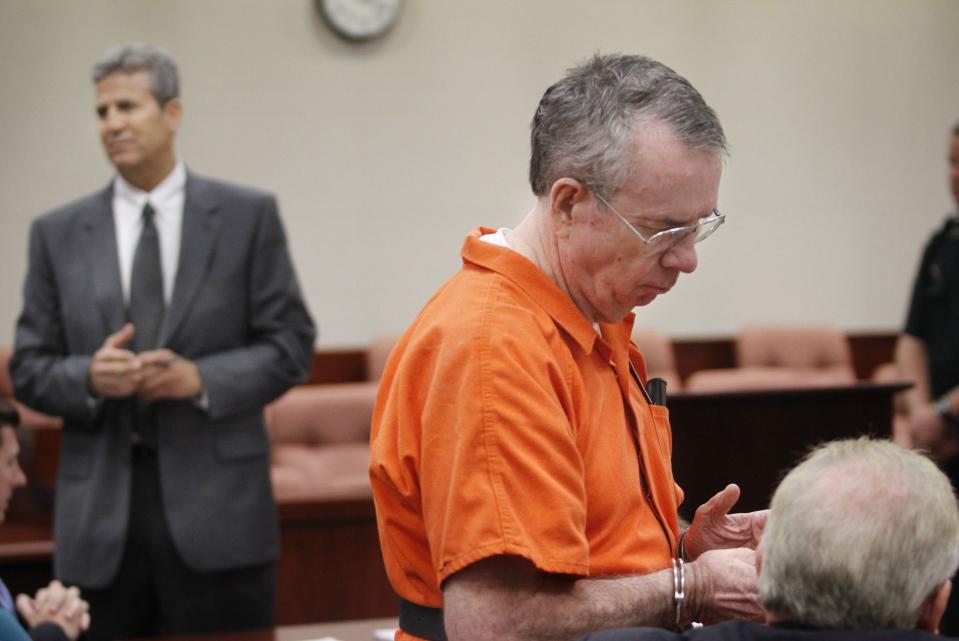 Ira Hatch, center, speaks with his attorney, Gregory Eisenmenger, right, while being questioned by Assistant State Attorney Lev Evans prior to Senior Judge James Midelis sentencing Hatch on Aug. 25, 2010 at the Indian River County Courthouse. Hatch accepted a racketeering plea deal and was ordered to serve 30 years in prison.