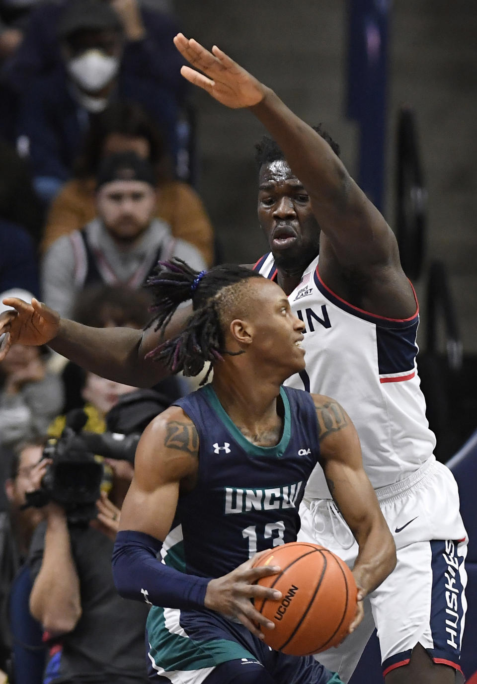 UNC Wilmington forward Trazarien White is guarded by Connecticut's Adama Sanogo, right, during the first half of an NCAA college basketball game Friday, Nov. 18, 2022, in Storrs, Conn. (AP Photo/Jessica Hill)