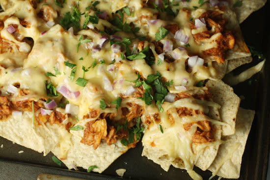 <strong>Get the <a href="http://www.macheesmo.com/2010/09/bbq-chicken-nachos/">BBQ Chicken Nachos recipe from Macheesmo</a></strong>