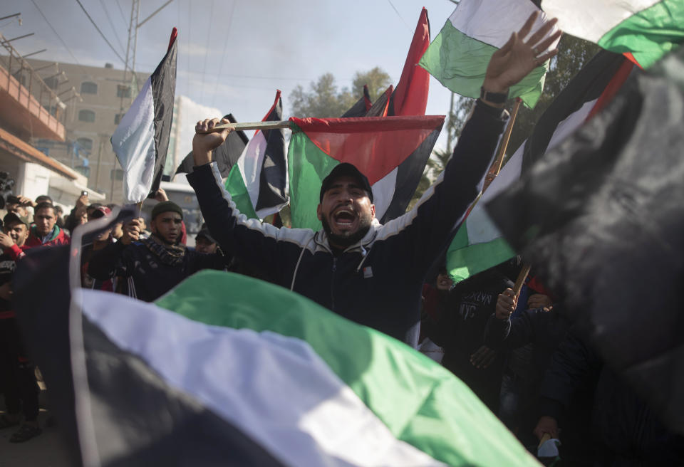 Palestinian protesters wave national flags and chant angry slogans during a protest against the U.S. Mideast peace plan, in Gaza City, Monday, Jan. 28, 2020. U.S. President Donald Trump is set to unveil his administration's much-anticipated Mideast peace plan in the latest U.S. venture to resolve the Israeli-Palestinian conflict. (AP Photo/Khalil Hamra)