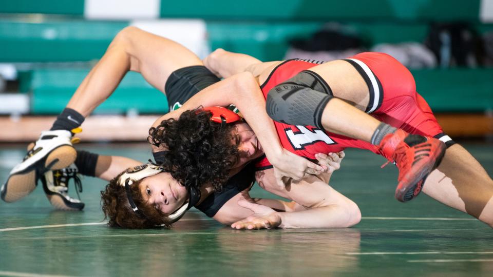 Kingsway's Jason Meola, right, works to escape a hold by  Camden Catholic's Lazarus Joyce during the 106 lb. bout of the wrestling meet held at Camden Catholic High School in Cherry Hill on Friday, January 27, 2023.   Meola defeated Joyce, 8-5.  