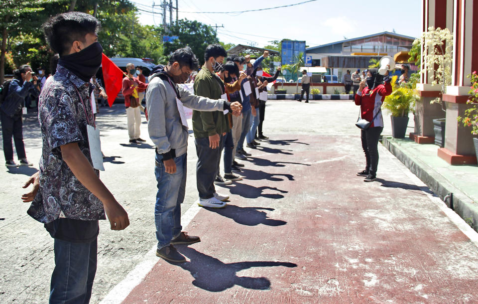 Students stage a solidarity protest outside the district court where the virtual sentencing hearing for seven Papuan pro-independence activists who are on trial on the accusation of treason is held in Balikpapan, East Kalimantan, Indonesia, Wednesday, June 17, 2020. The court sentenced the activists to nearly yearlong jail terms on treason charges for organizing anti-racism protests last year, despite calls from rights groups and politicians to drop the charges and release them. (AP Photo/Andi Muhammad Hafizh)