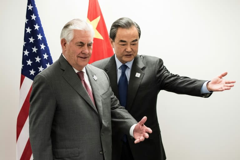 US Secretary of State Rex Tillerson (left) and China's Foreign Minister Wang Yi take their seats before a meeting at the World Conference Center in Bonn, western Germany, on February 17, 2017