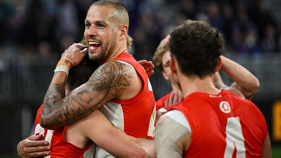 Buddy Franklin celebrates with Sydney Swans teammates after a goal.