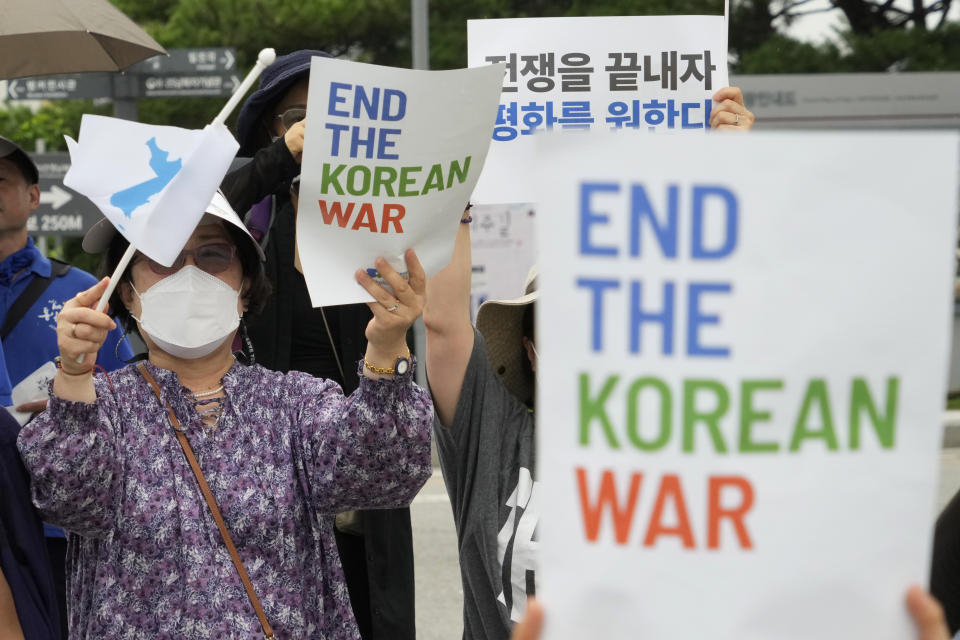 FILE - A participant waves a reunification flag during a rally for peace unification of the Korean peninsula at the Imjingak Pavilion in Paju, South Korea, near the border with North Korea, Saturday, July 23, 2022. In a Friday, Aug. 19, 2022, commentary published by local media, Kim Yo Jung, sister of North Korean leader Kim Jong Un, says her country will never accept South Korean President Yoon Suk Yeol’s “foolish” offer of economic benefits in exchange for denuclearization steps, accusing Seoul of recycling past proposals Pyongyang already rejected. (AP Photo/Ahn Young-joon, File)