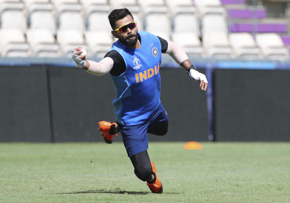 India's captain Virat Kohli dives to catch the ball during a training session ahead of their Cricket World Cup match against South Africa at Ageas Bowl in Southampton, England, Saturday, June 1, 2019. (AP Photo/Aijaz Rahi)