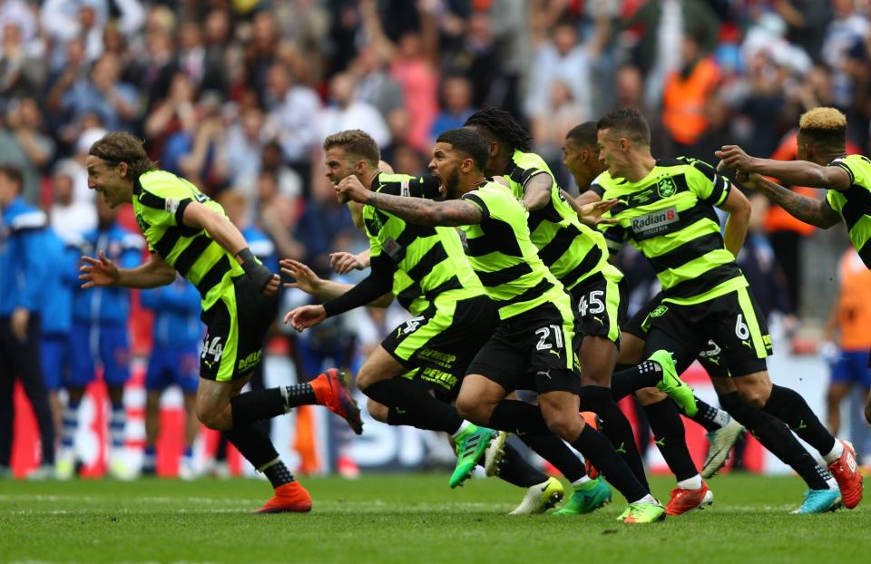 Huddersfield celebrate as the winning penalty hits the net