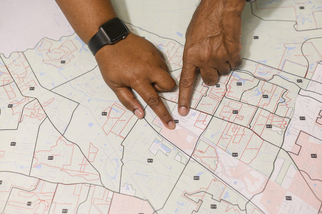 Constituents going over the map of the proposed Baton Rouge-St. George’s division line in Baton Rouge, La., on Oct. 3, 2019. (Emily Kask/The New York Times)