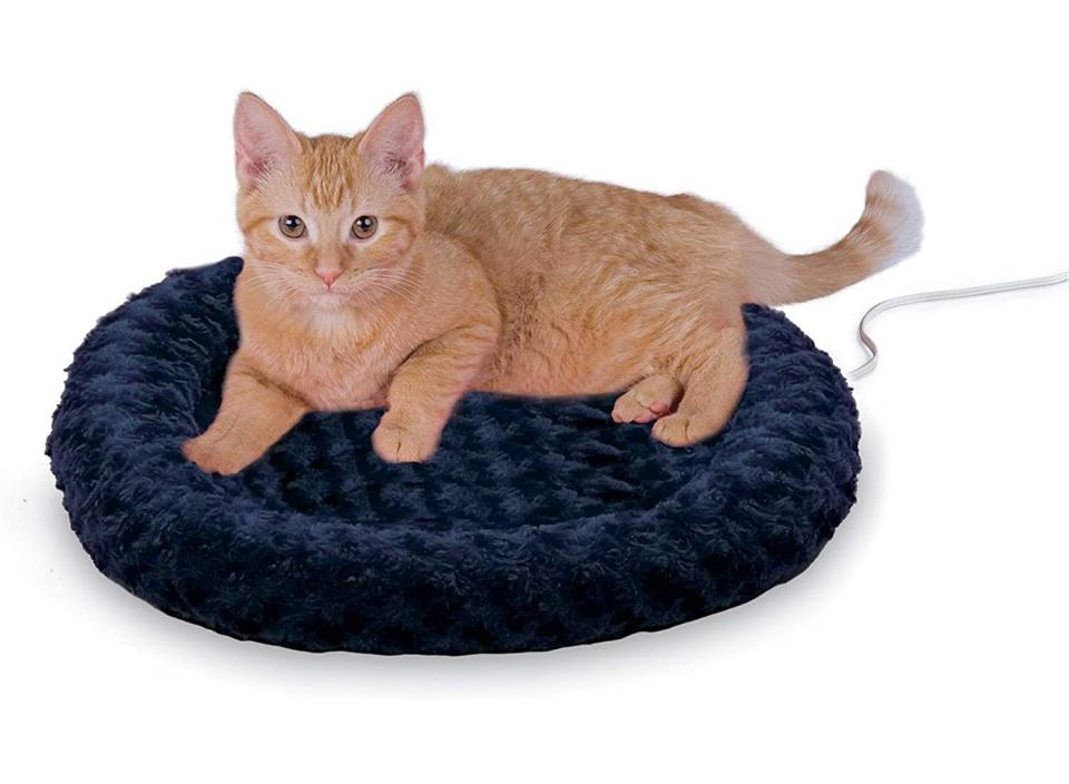 Keep your kitty nice and warm with this plush, heated cat bed. (Source: Amazon)