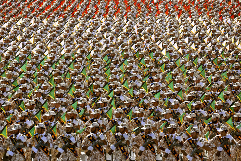 FILE - In this Sept. 22, 2014 file photo, members of the Iran's Revolutionary Guard march during an annual military parade at the mausoleum of Ayatollah Khomeini, outside Tehran, Iran. On Monday, April 8, 2019, the Trump administration designated Iran’s Revolutionary Guard a “foreign terrorist organization” in an unprecedented move against a national armed force. Iran’s Revolutionary Guard Corps went from being a domestic security force with origins in the 1979 Islamic Revolution to a transnational fighting force. (AP Photo/Ebrahim Noroozi, File)