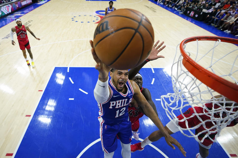 Philadelphia 76ers' Tobias Harris (12) goes up for a shot past Toronto Raptors' Pascal Siakam (43) during the first half of Game 5 in an NBA basketball first-round playoff series, Monday, April 25, 2022, in Philadelphia. (AP Photo/Matt Slocum)