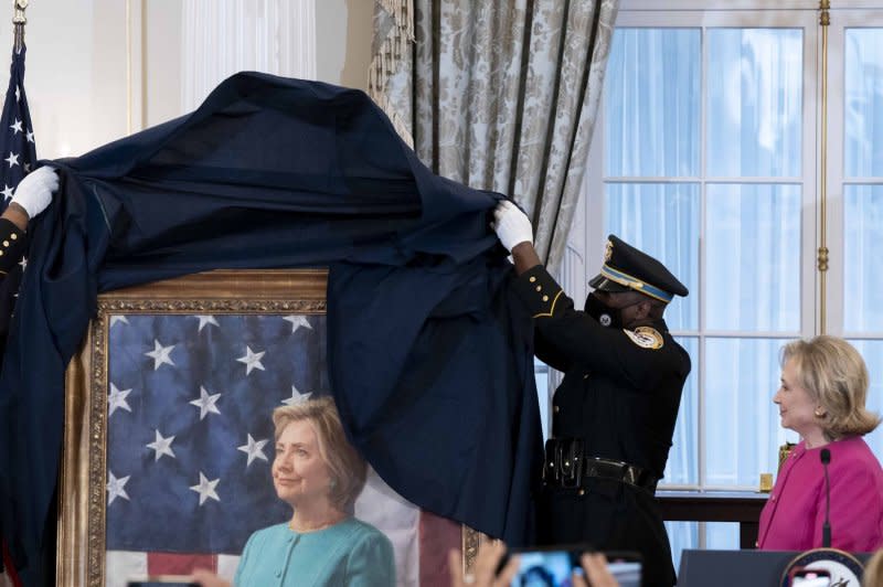 Former Secretary of State Hillary Rodham Clinton looks on Tuesday as her portrait is unveiled during a ceremony at the U.S. State Department in Washington, D.C. Photo by Bonnie Cash/UPI