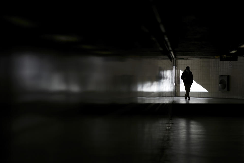 A man enters a subway station in Lisbon, Thursday, Jan. 6, 2022. (AP Photo/Armando Franca)