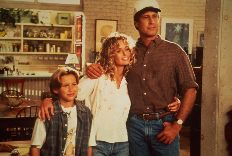 Jonathan Taylor Thomas, Farrah Fawcett, and Chevy Chase pose on set of 1995's "Man of the House"
