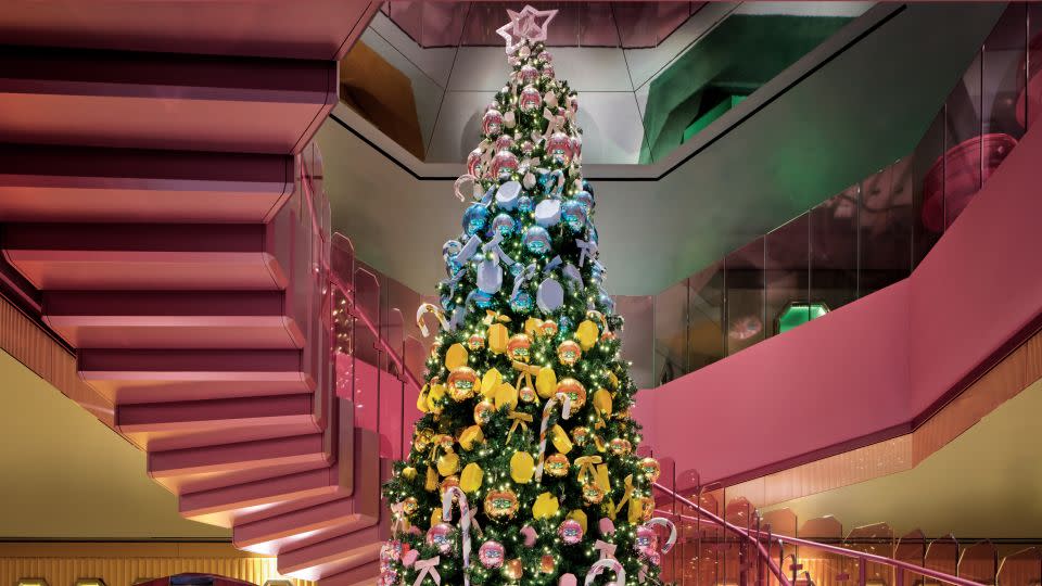 Given the season, the store currently features a large-scale Christmas tree, decorated in an ombré pattern with baubles and jewel-shaped gift boxes whose color palette matches the space just so. - Swarovski