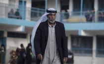 Palestinians take shelter provided by the U.N. at a school after fleeing their homes from the overnight Israeli heavy missile strikes on their neighborhoods in the outskirts of Gaza City, Friday, May 14, 2021. (AP Photo/Khalil Hamra)