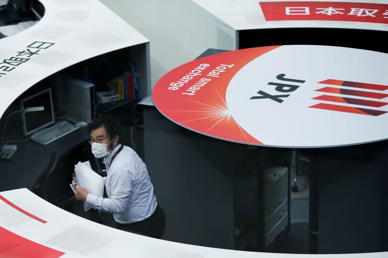 A staff member of the Tokyo Stock Exchange (TSE) is seen at the empty trading space after the TSE temporarily suspended all trading due to system problems in Tokyo