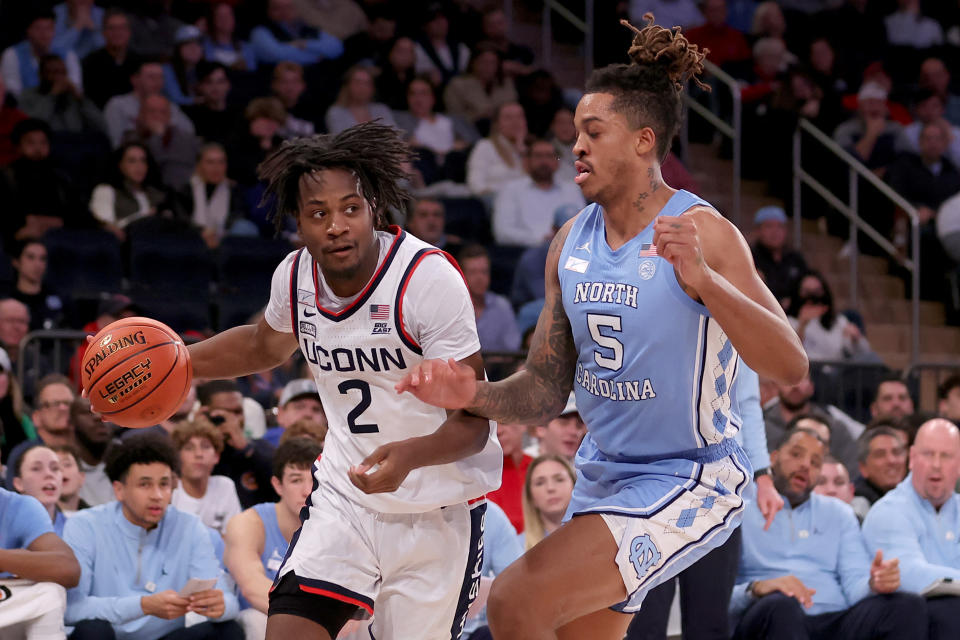 Tristen Newton, left, and the Huskies got the best of the Tar Heels at Madison Square Garden. (Brad Penner/Reuters)