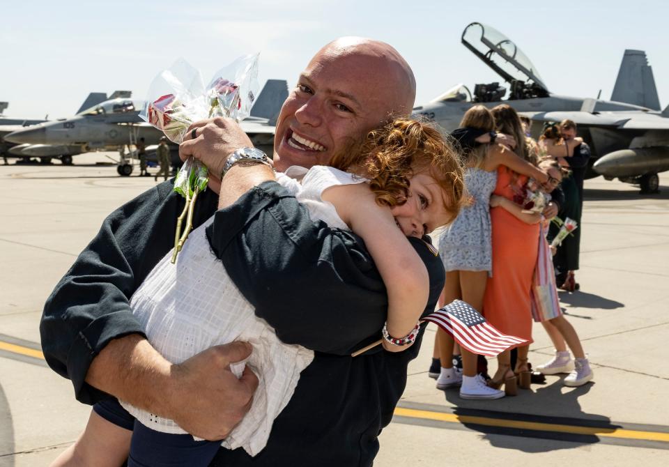 Kelty Lanham gets a hug as families and friends as they celebrate the return of Carrier Air Wing Seventeen and its four squadrons to Naval Air Station Lemoore in California, after a nearly 7-month deployment to the Western Pacific on the USS Nimitz.
