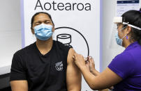 New Zealand olympian shot putter Dame Valerie Adams reacts as she receives her COVID-19 vaccination in Auckland, New Zealand, Monday, April 17, 2021. Some wealthy nations that were most praised last year for controlling the coronavirus are now lagging far behind in getting their people vaccinated — and some, especially in Asia, are seeing COVID-19 cases grow. (Brett Phibbs/New Zealand Herald via AP)