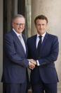 French President Emmanuel Macron, right, shakes hands with Australian Prime Minister Anthony Albanese, Friday, July 1, 2022 at the Elysee Palace in Paris. Australia and France opened a "new chapter" in relations as the new Australian prime minister seeks to heal wounds caused by a secret submarine contract that infuriated France. (AP Photo/ Thomas Padilla)