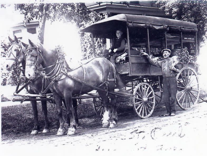 Peddlers with draft horses and covered wagon