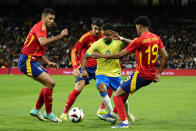 Brazil's Rodrygo, centre right, tries to get past Spain's Rodrigo, left, Alvaro Morata, 2nd left and Lamine Yamal during a friendly soccer match between Spain and Brazil at the Santiago Bernabeu stadium in Madrid, Spain, Tuesday, March 26, 2024. (AP Photo/Jose Breton)