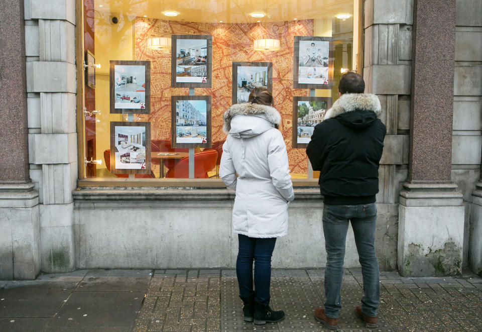 Embargoed to 0001 Friday August 25 File photo dated 04/12/14 of a couple looking in the window of an estate agents, as nearly half of 18 to 35 year-olds are banking on a partner to help them get onto the property ladder, according to research.